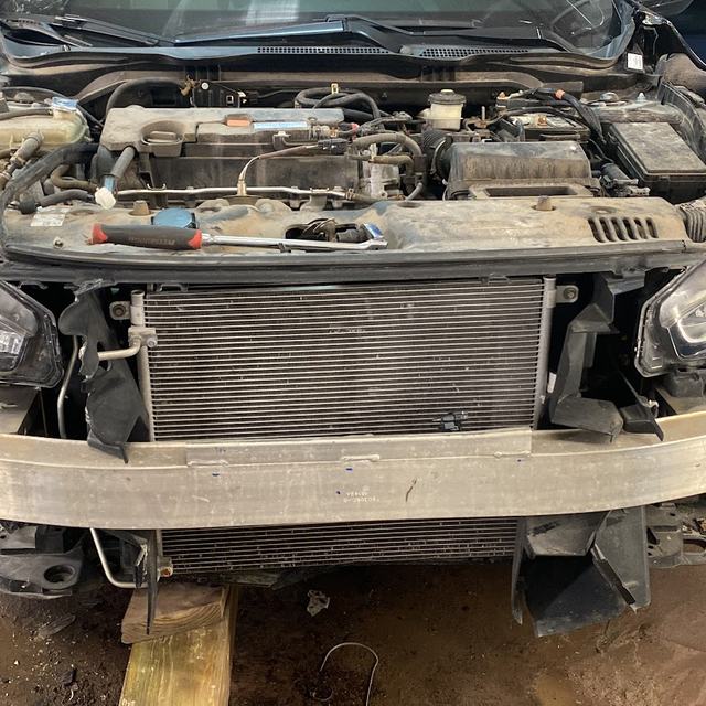 Collision-damaged car stripped for repair